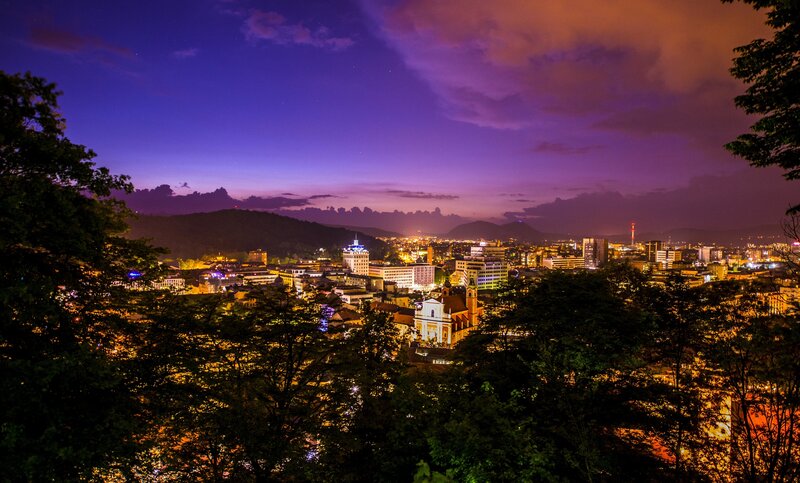 city at twilight with purple sky