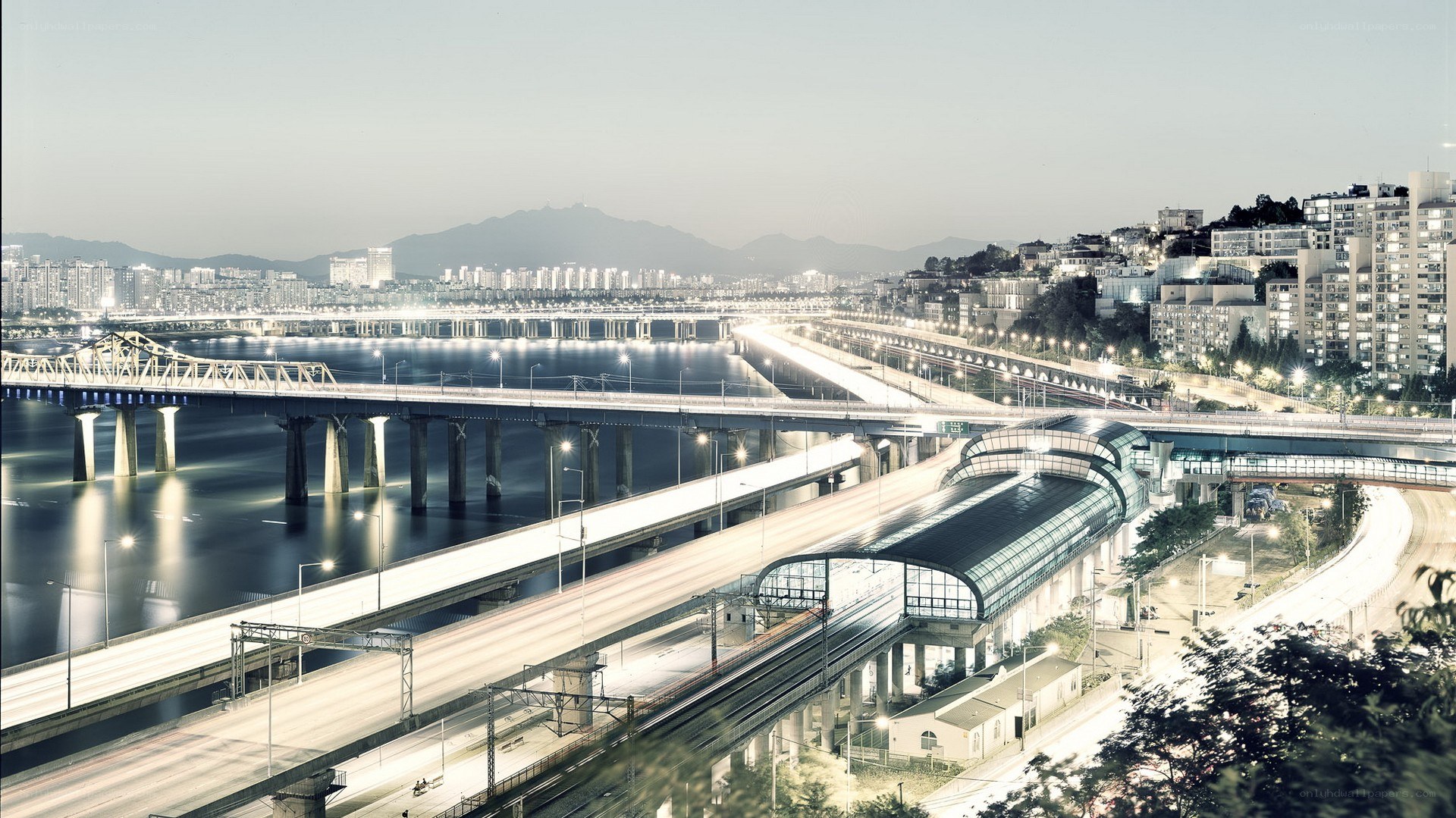 City bridge and train station at dusk