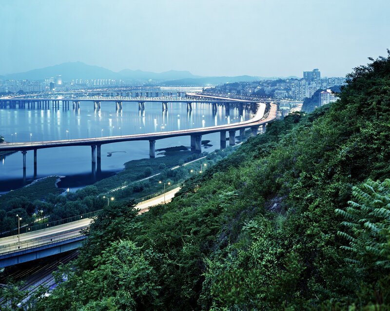 City bridges over river at dusk