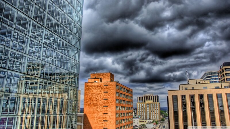 City Buildings under Storm Clouds
