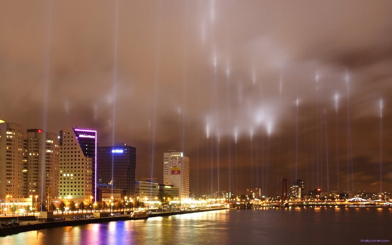 City lights and laser beams at night