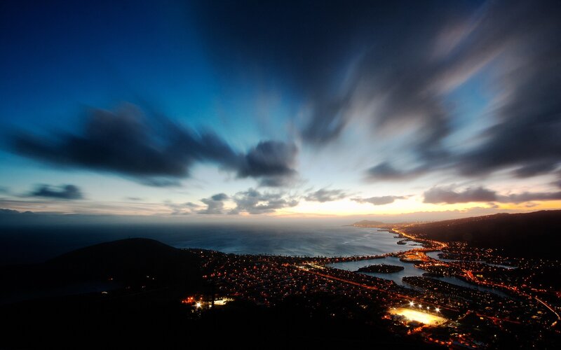 City lights at dusk by the sea