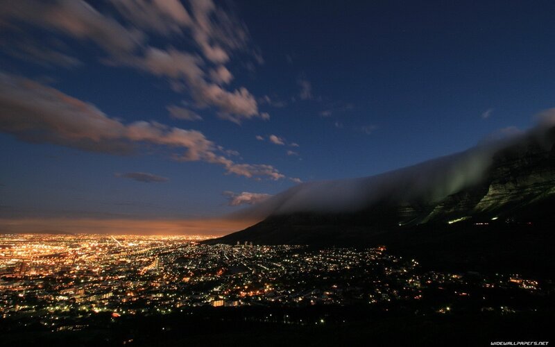 City lights at night with mountain