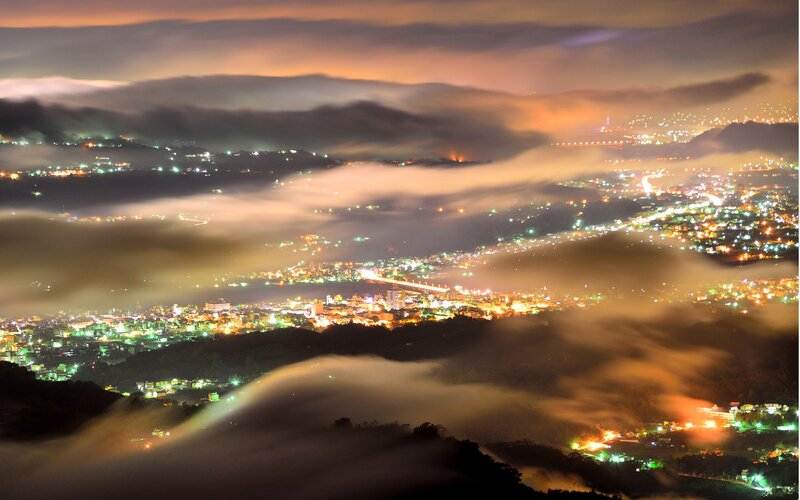 City lights over foggy valley