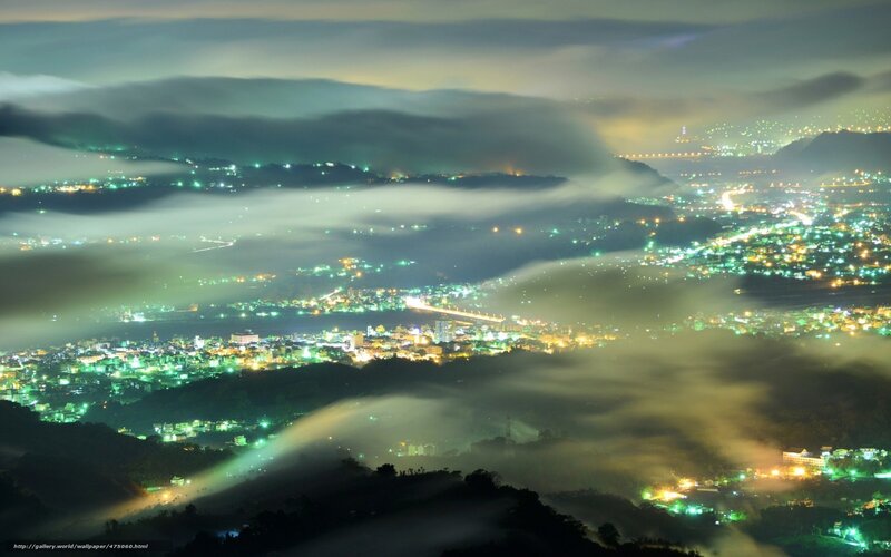 City lights over foggy valley
