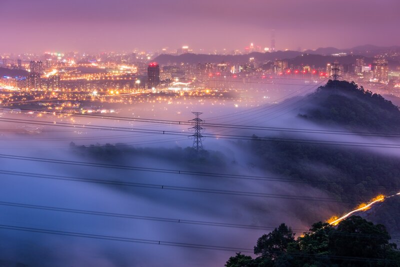 City lights through morning fog