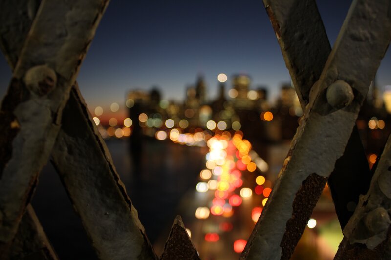 City Lights Through Railing