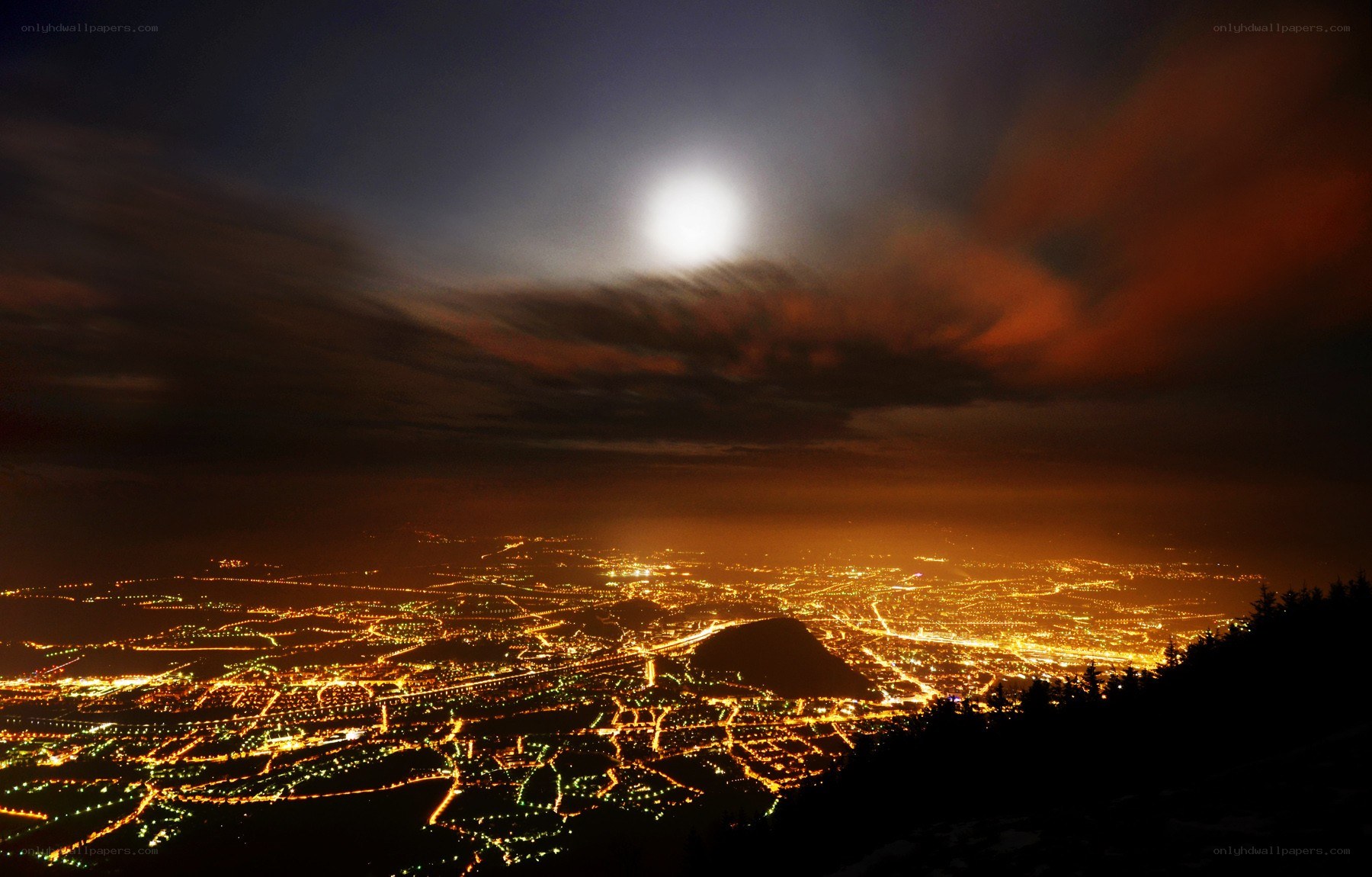 City lights under a full moon