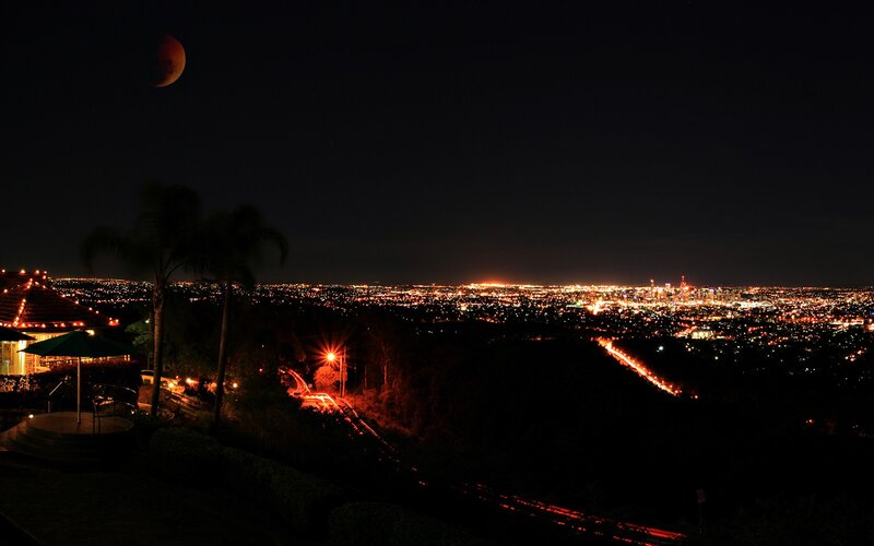 city lights under a lunar eclipse