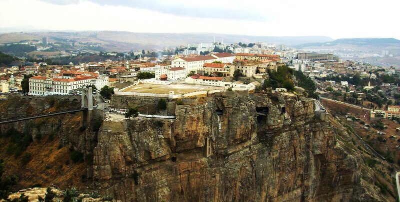 city on a cliff with bridge