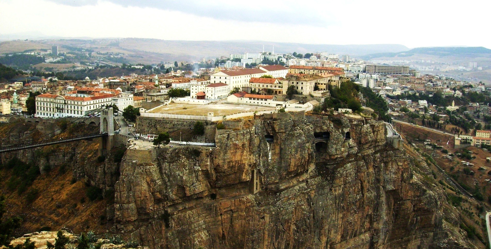 city on a cliff with bridge