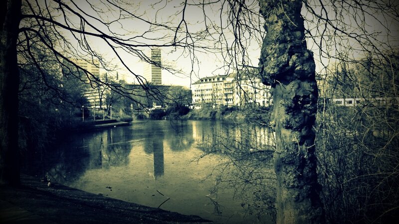 City park with lake and buildings
