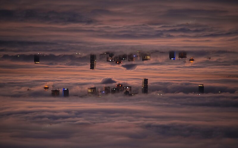 City Skyline Above Clouds — Purple