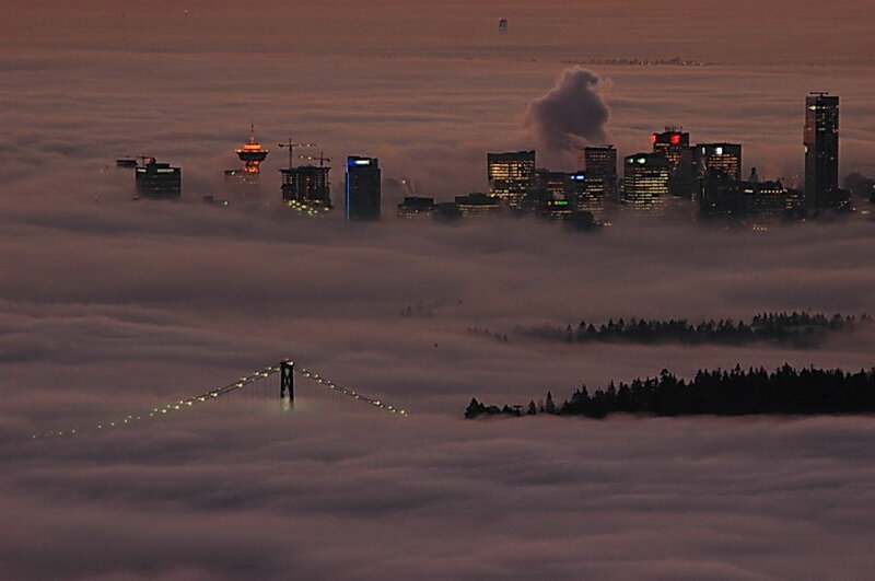 City skyline above fog