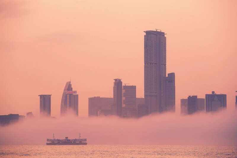 City skyline at dawn with fog