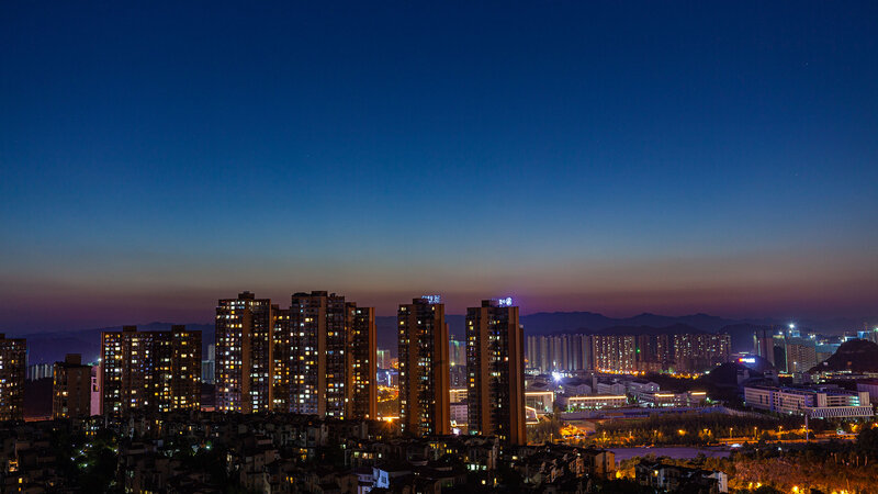 City Skyline at Dusk — Blue, Calm, Night, Photograph, Buildings, Mountains