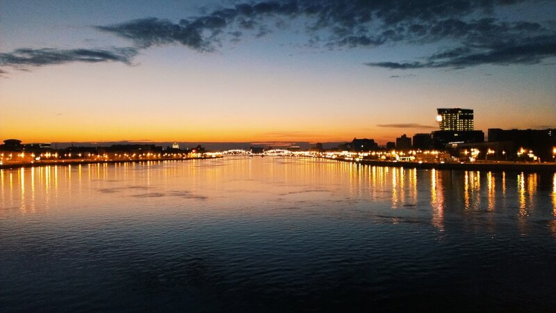 City Skyline at Dusk — Blue, Serene, Sunset, Photograph, River, Bridge, Buildings
