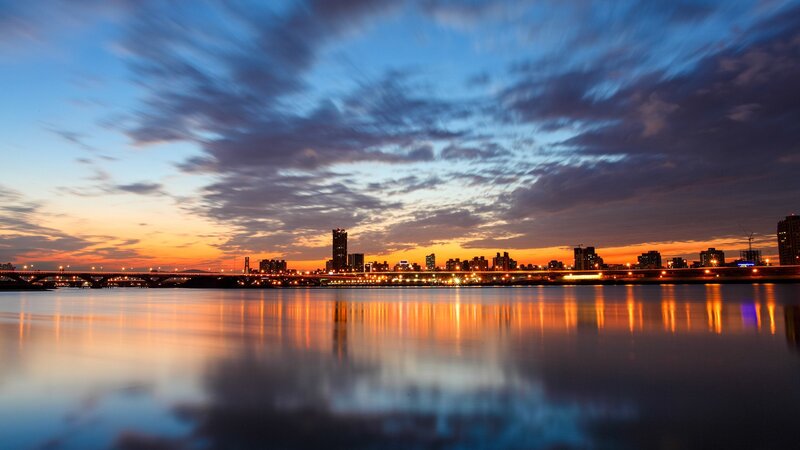 City Skyline at Dusk — Blue, Serene, Sunset, Photograph, River, Bridge