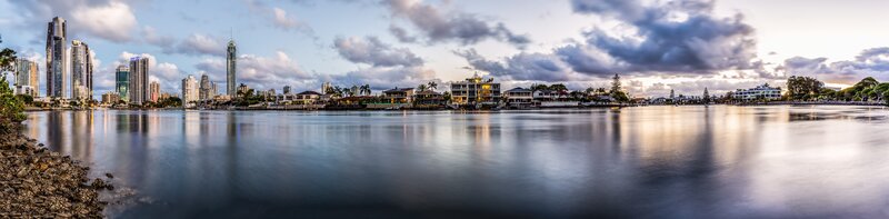 City Skyline at Dusk — Blue, Serene, Sunset, Photograph, Skyscrapers, River, Houses