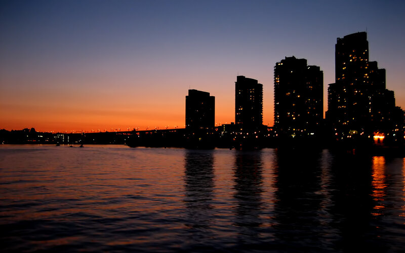City Skyline at Dusk — Orange, Serene, Sunset, Photograph, Buildings, Water