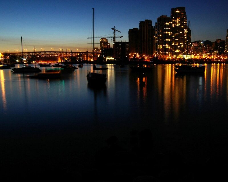 City skyline at dusk with boats