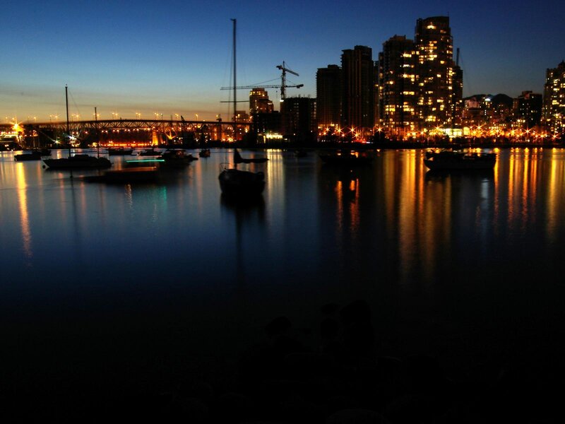 City skyline at dusk with boats