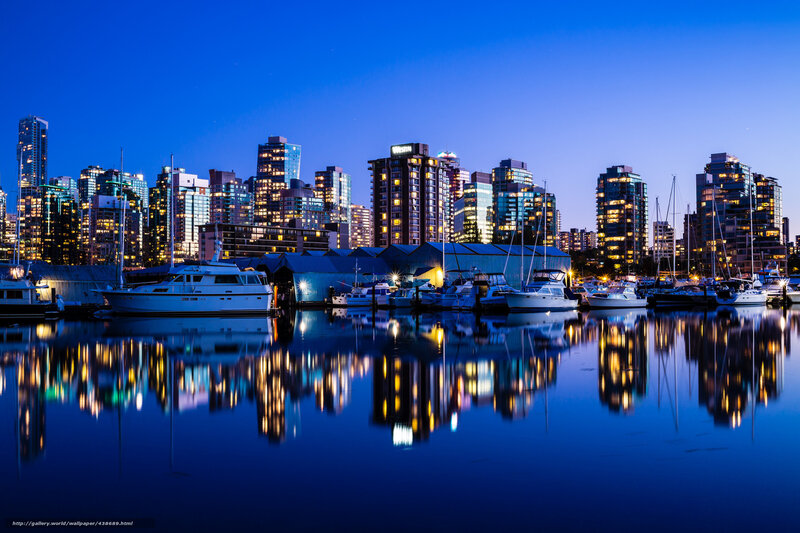 City skyline at dusk with boats