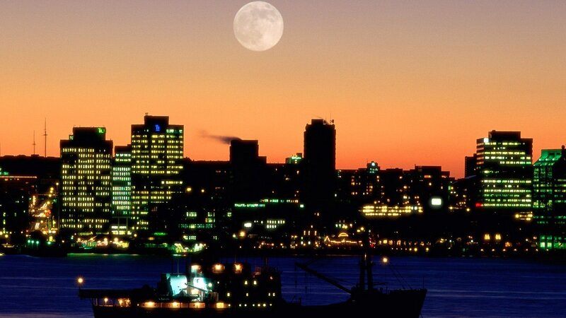 City skyline at dusk with full moon