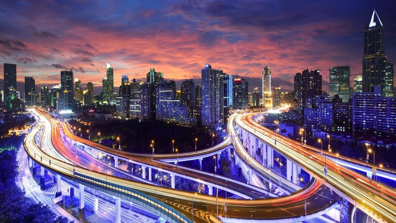 City skyline at dusk with highways