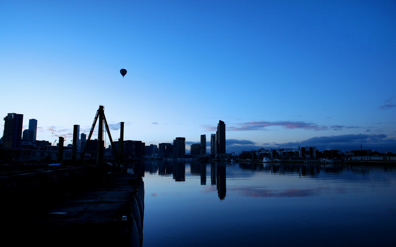 City skyline at dusk with hot air balloon