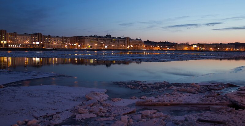 City skyline at dusk with icy river