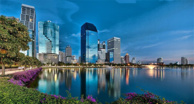 City skyline at dusk with lake