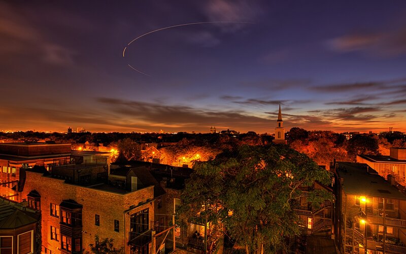 City skyline at dusk with light trails