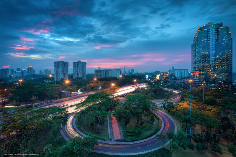 City skyline at dusk with light trails