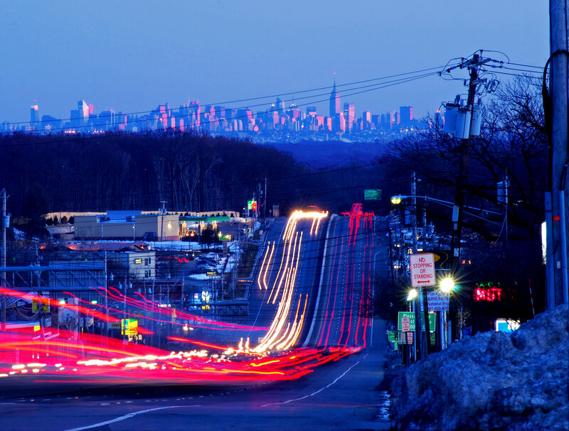 City skyline at dusk with light trails