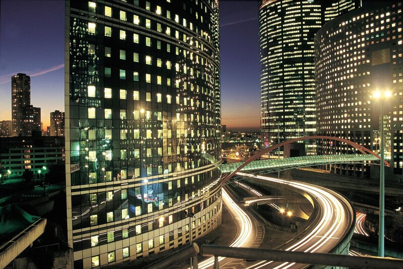 City skyline at dusk with light trails
