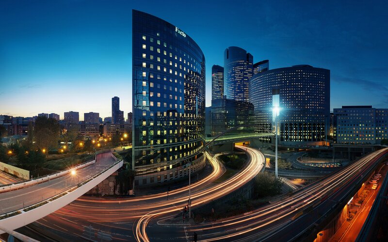 City skyline at dusk with light trails