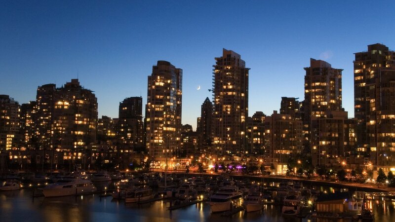 city skyline at dusk with moon