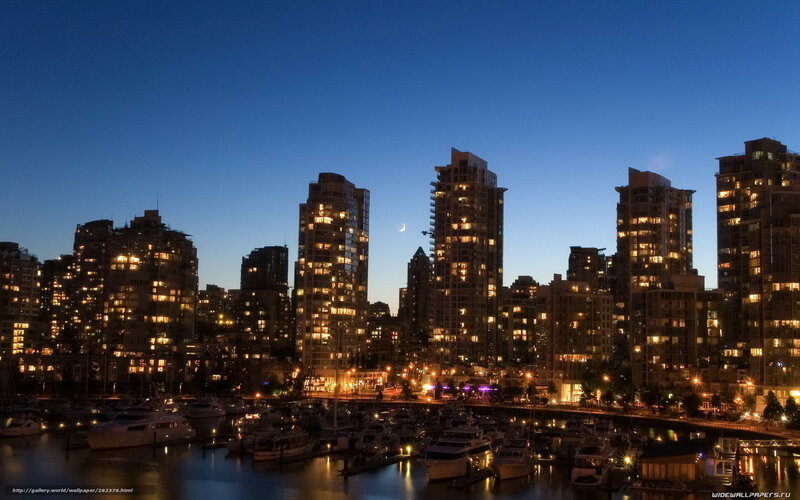 City skyline at dusk with moon