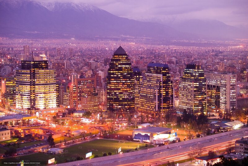 City skyline at dusk with mountains