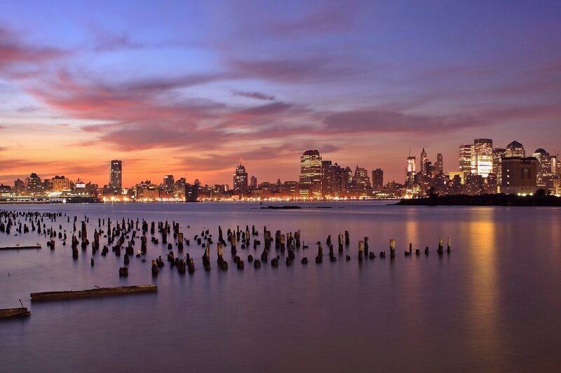 City skyline at dusk with old pilings