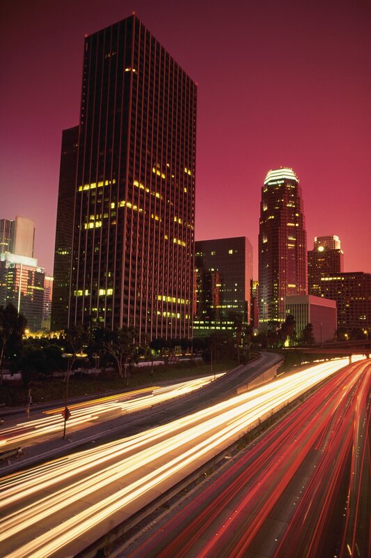 City skyline at dusk with traffic