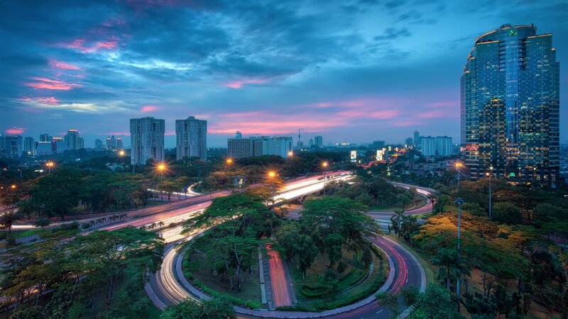 City skyline at dusk with traffic