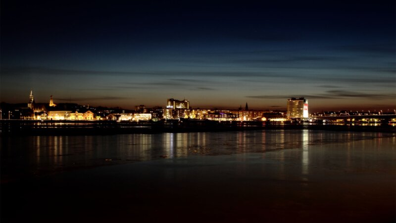 City Skyline at Night — Black, Calm, Photograph, River, Buildings