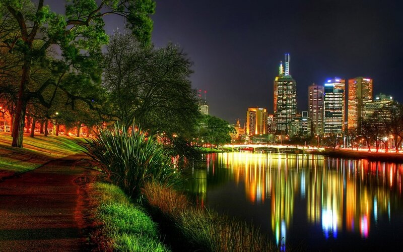 City Skyline at Night — Black, Serene, Photograph, River, Trees, Bridge, Yellow