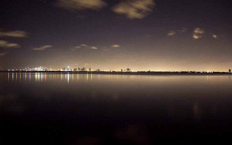 City Skyline at Night — Black, Serene, Photograph, Water