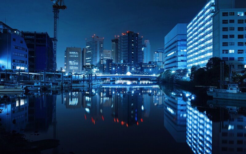 City Skyline at Night — Blue, Calm, Photograph, Buildings, River, Bridge