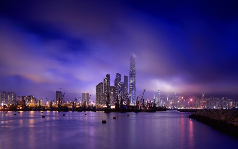 City Skyline at Night — Blue, Dramatic, Photograph, Skyscrapers, Cranes, Water