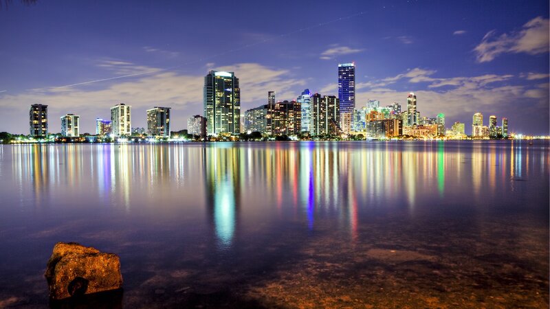 City Skyline at Night — Blue, Serene, Photograph, Buildings, Water, Rock