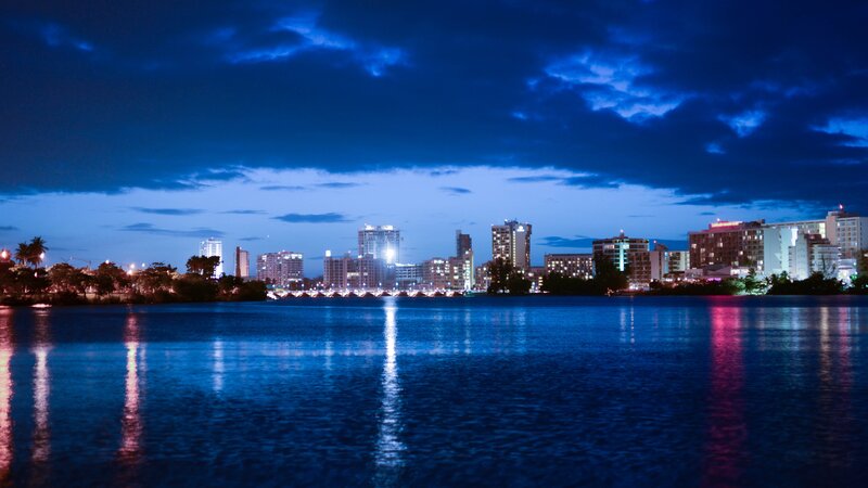 City Skyline at Night — Blue, Serene, Photograph, Buildings, Water, Sky, Black